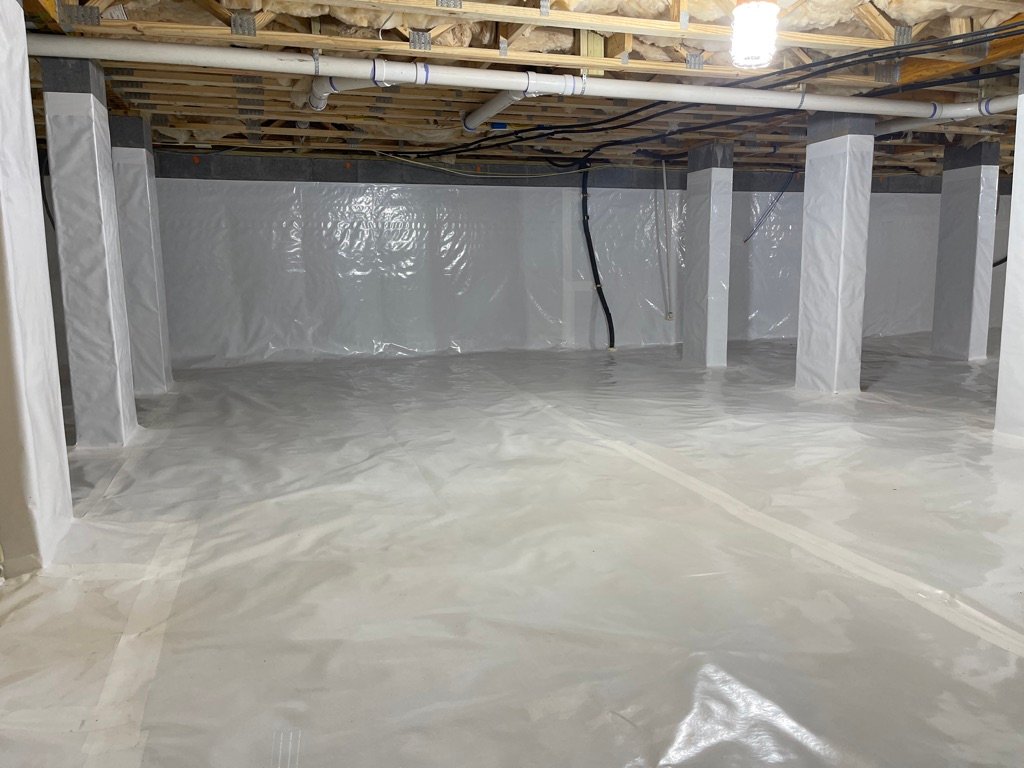 Crawlspace with white polyethylene vapor barrier encapsulation and concrete support columns