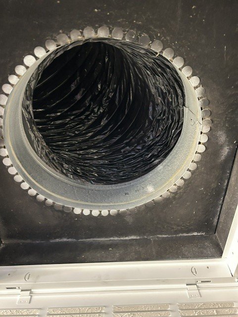 Interior of air duct with visible dust and debris buildup before cleaning