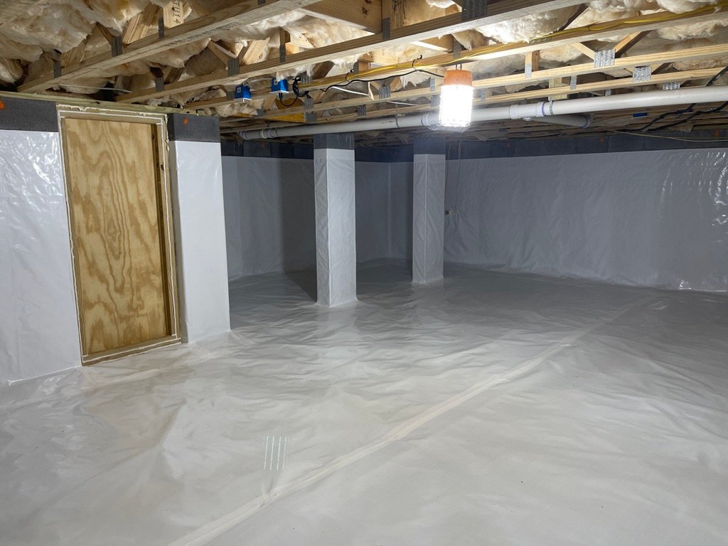 Crawlspace with white vapor barrier encapsulation, support columns, and HVAC ducts