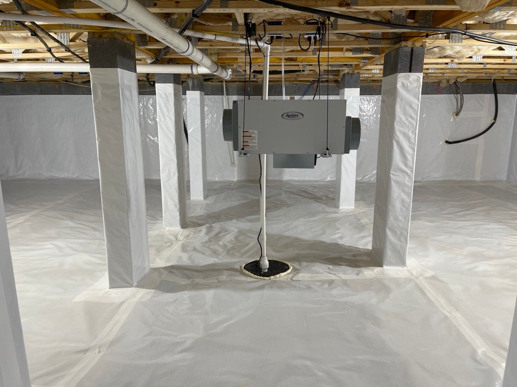 Crawlspace with white vapor barrier encapsulation and mounted dehumidifier unit
