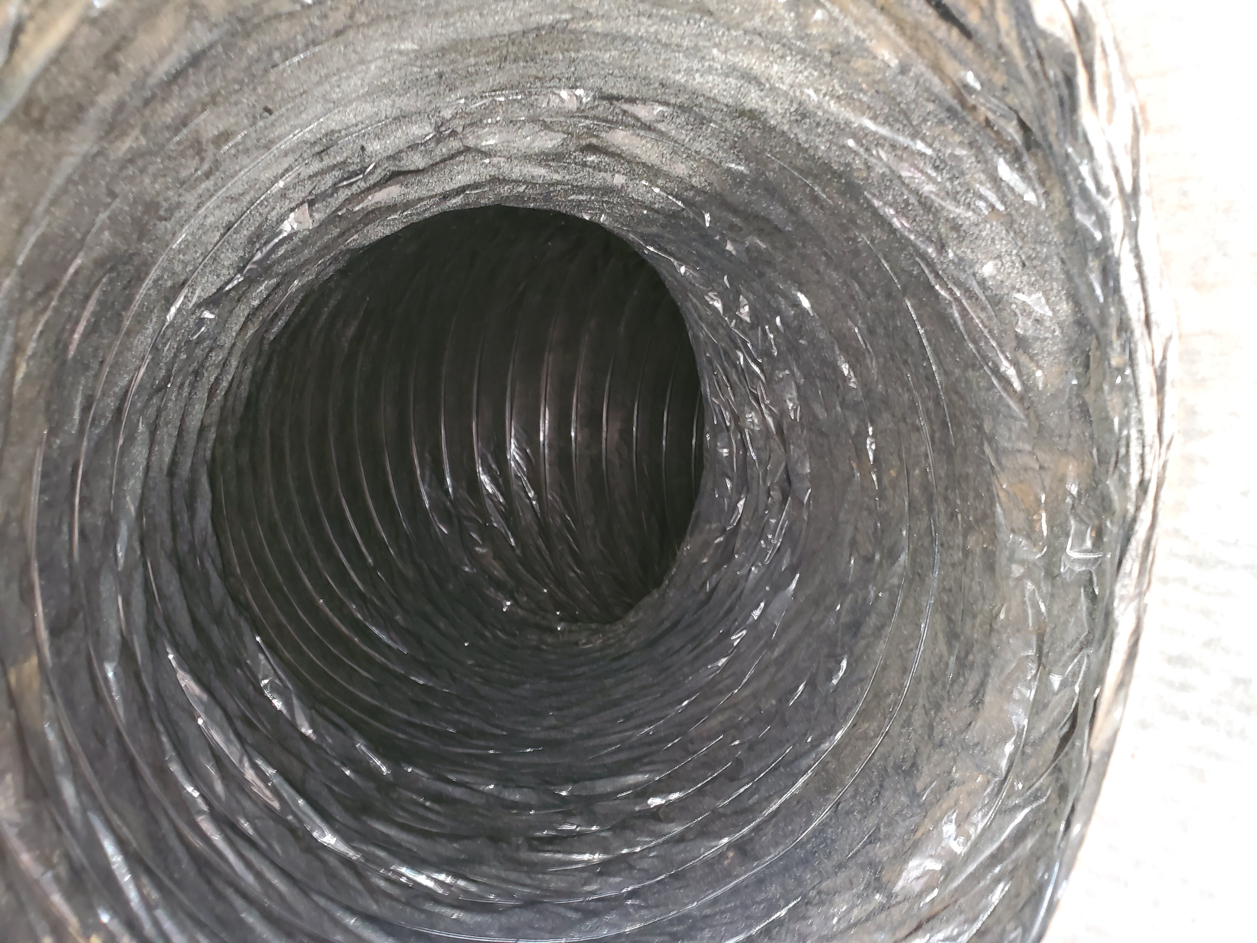 Clean interior of metal spiral air duct after professional cleaning service